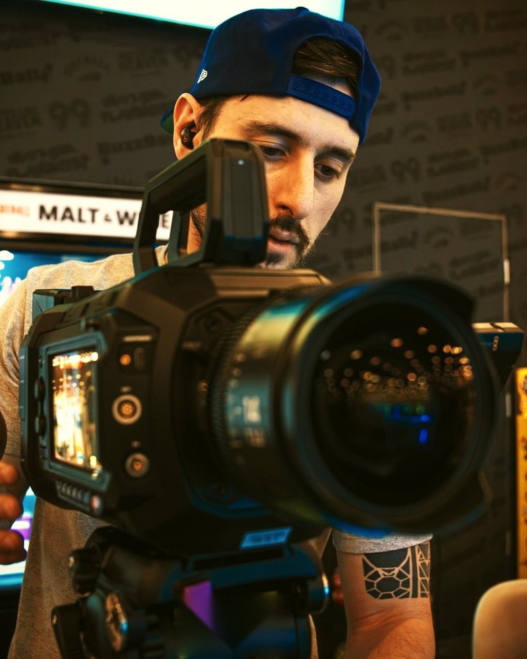 Garrett Krumpe operating a cinema camera on set